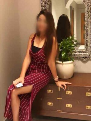 Girl in maroon dress siting in front of mirror